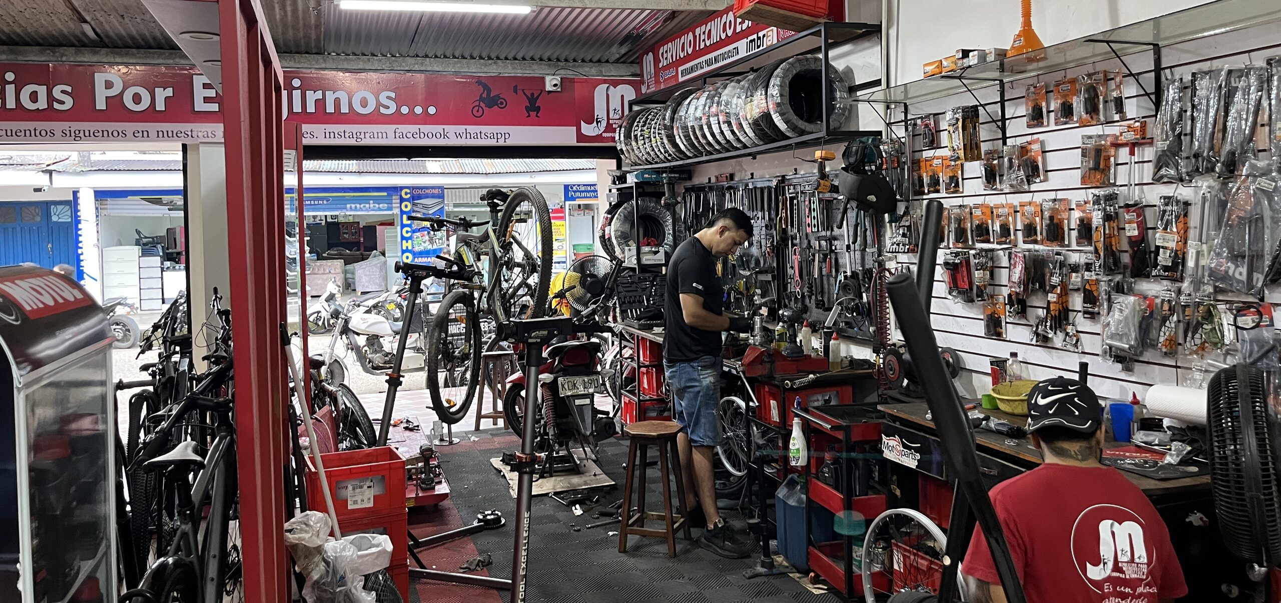 Técnico de JM Repuestos haciendo mantenimiento a una bicicleta en el taller
